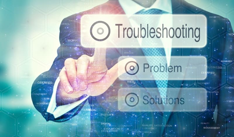 A person in a suit is interacting with an online transparent screen displaying options: "Troubleshooting," "Problem," and "Solutions." The background features digital patterns and blue hexagons, enhancing the tech-driven problem-solving theme.