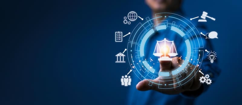 A person in a suit reaches towards a digital interface displaying a scale of justice, reminiscent of Georgia's legal system, surrounded by icons like a gavel, globe, lightbulb, and gears. This scene symbolizes the intersection of law and technology against a blue backdrop.