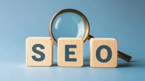 Wooden blocks spelling "SEO" sit in front of a magnifying glass, symbolizing the clarity expert SEO services bring to your digital strategy, all set against a blue background.