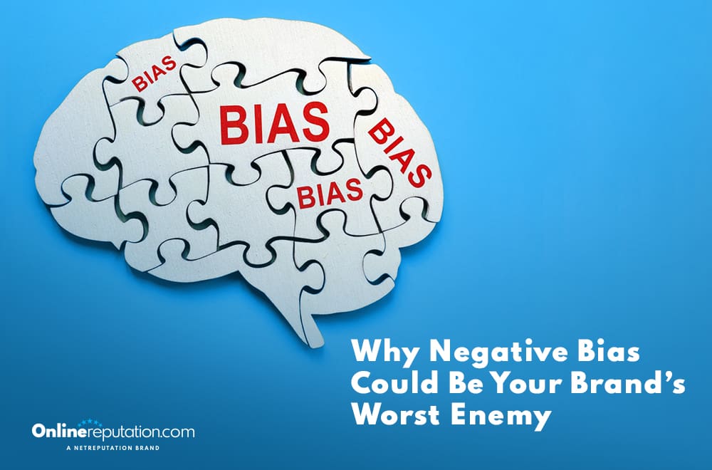 Illustration of a brain crafted from puzzle pieces labeled "BIAS" in red. Text reads "Why Negative Bias Could Be Your Brand’s Worst Enemy." In the corner, "OnlineReputation.com A NetReputation Brand" stands as a reminder of the impact negative bias can have on perception.